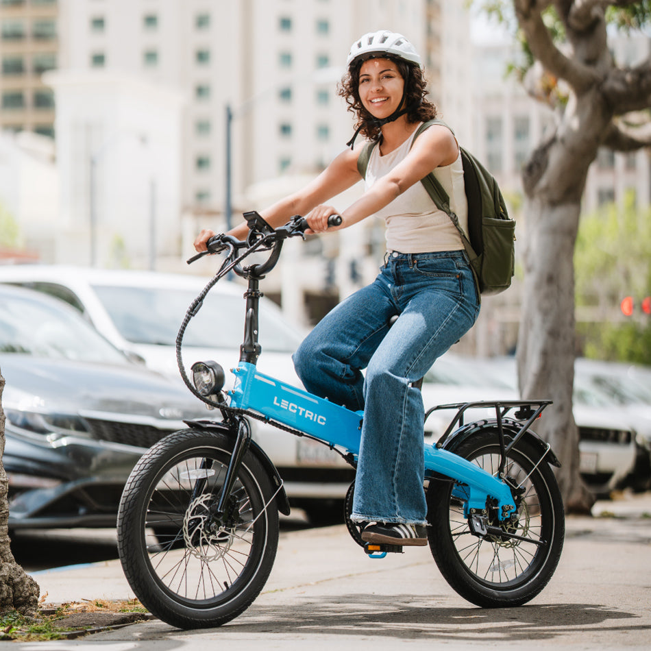 Rider on a Lectric XP Lite 2.0 folding e-bike in Lectric Blue